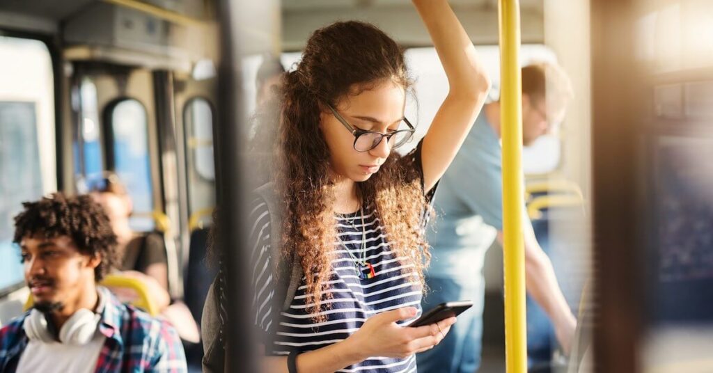 Woman Using Phone On Bus.jpg